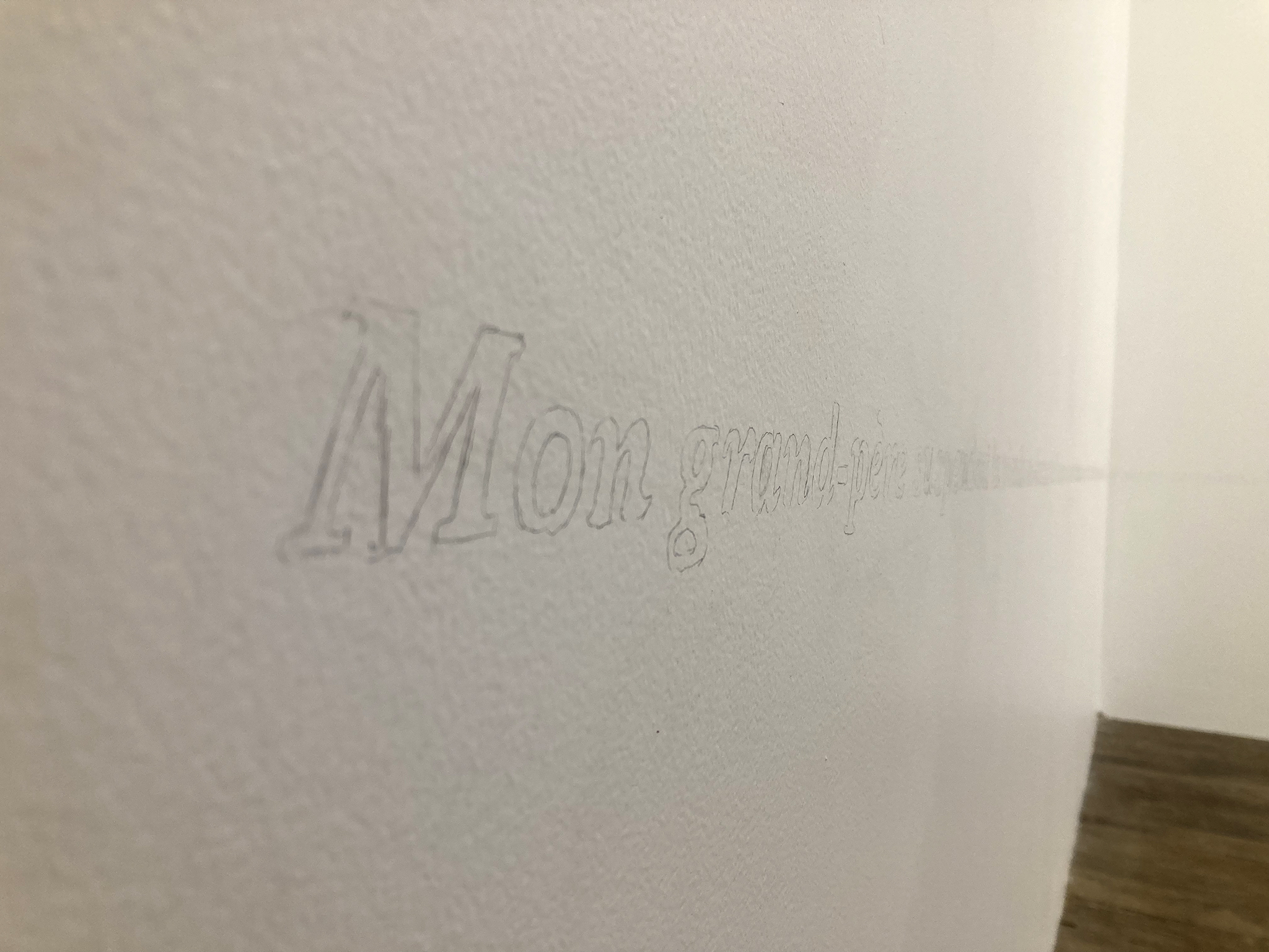 Texte écrit au crayon à papier sur le mur : Mon grand père suspendait la viande...
